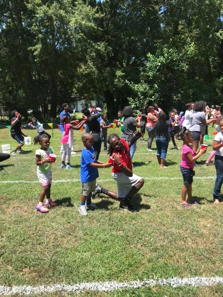 Families playing together during a community field activity